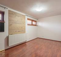 A room with a wooden decor floor and sound insulation in a 5 or more room apartment.