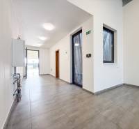 Interior of a commercial space with a tiled floor and glass doors.