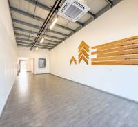 Commercial spaces with wood-patterned flooring and wall decoration.