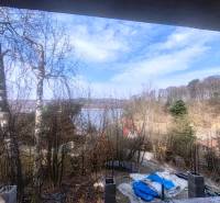 View of the lake from the Cottage at Zajacia debra in Holčíkovce surrounded by forest.
