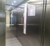 A metal elevator cabin with lighting and a mirror in a 3-room apartment.