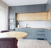 A kitchen in a 3-room apartment with wooden decor and large windows.