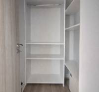 Built-in wardrobe in a 3-room apartment with a wooden decor floor.