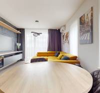 Living room with a corner sofa and television, wooden decor flooring, 3-room apartment.