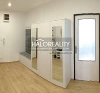 Entrance hall with a mirrored wardrobe and a floor with a wooden decor in a 3-room apartment.
