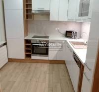 Entrance hall in a 3-room apartment with a round mirror and wooden decor flooring.