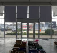 Interior of commercial premises in Bratislava with large glass doors and storage boxes.