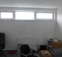 A room with a window and office chairs in commercial premises.