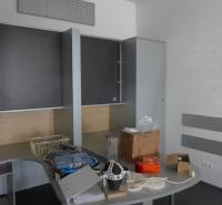 Office with storage cabinets and a desk with various items on it.