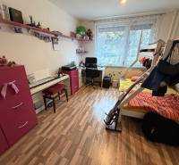 A room in a 3-room apartment with a bunk bed, a desk, and a floor with a wooden decor.