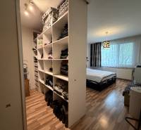 Bedroom in a 3-room apartment with storage space and flooring with a wood decor.