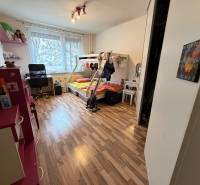 Children's room with wood-patterned flooring, a bunk bed, and a desk.