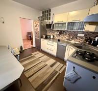 A kitchen in a 3-room apartment with a gas cooktop and tiled backsplash.