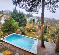 View of the surrounding houses and trees with a pool in the garden on Dolná Street.