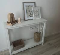 White console with decorations, wooden floor decor, 2-room apartment.