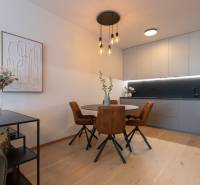 Kitchen in a 2-room apartment with a dining table, wooden decor flooring.