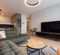 Living room in a 2-room apartment with a wooden decor floor and stylish furniture.