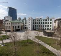 Courtyard with a historic building, modern elements, and greenery in Bratislava on Páričkova Street.
