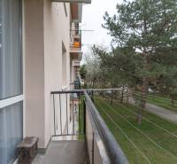 The balcony of an apartment building on Planét Street in Bratislava - Ružinov with a view of greenery.