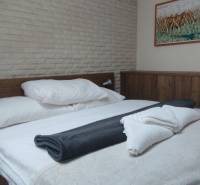 A bedroom with wooden furniture and a painting, a floor with a wooden decor, a two-room apartment.