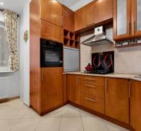 A kitchen in a 3-room apartment, equipped with wooden decor and a gas stove.
