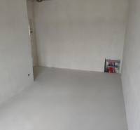 Spacious room with white walls and wiring in a family house.