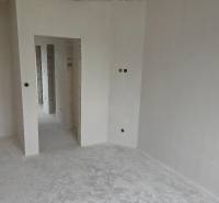 A white room with passages in a family house, ready for completion.