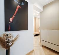 Interior of a 2-room apartment with a wooden decor floor and modern artwork.