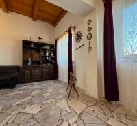 The interior of the cabin with a stone floor and a wooden ceiling.