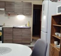 Kitchen in a 3-room apartment with a table, chairs, and a kitchen unit.