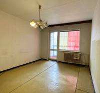 A room in a 3-room apartment with a balcony, simple walls and lighting.