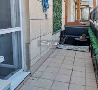Balcony with tiles, comfortable seating, and greenery at a 3-room apartment in Bratislava - Old Town.