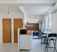 A kitchen in a 3-room apartment with white walls and appliances, and a floor with a white decor.