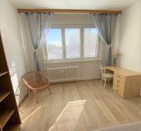 A bright room in a 4-room apartment with a wooden decor floor and a work corner.