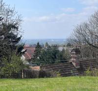 Gardens with a view between trees and rooftops on Budovateľská Street, Marianka, Residential plots.