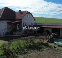 A family house in Rimavské Janovce, with a red roof and a spacious garden.