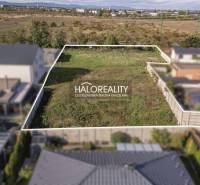 A plot of land for residential use in Senec, enclosed by a fence, suitable for building a home.