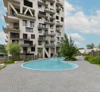 Residential complex with a swimming pool on Polianky Street in Bratislava, Dúbravka, surrounded by greenery.