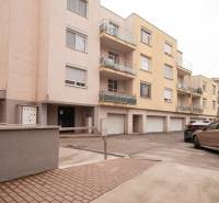 Apartment building on Na pažiti Street, Bratislava - Nové Mesto, with a parking lot and balconies.