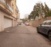 Na pažiti Street, Bratislava - Nové Mesto, shows a parking lot and residential buildings with garages.