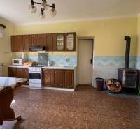 A kitchen in a family house with a wooden floor decor and traditional interior.