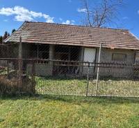 A family house on Hlavná Street in Radava with simple fencing and a lawn.
