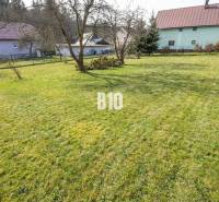 A garden with fruit trees surrounded by buildings in Raková for plots - housing.