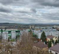 The view from Kotrádova Street in Prešov towards the apartment buildings and nearby mountains.