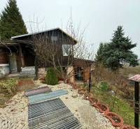 A cottage in Žilina surrounded by greenery with a view of the city.
