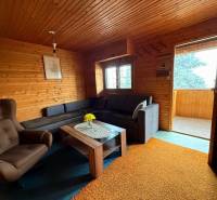 Interior of a cabin with seating and wooden paneling.