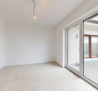 Interior of a family house with an exit to the terrace and an uninstalled floor.