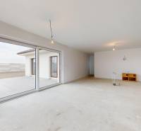 A family house with a spacious living room, large window, and a view of the terrace.