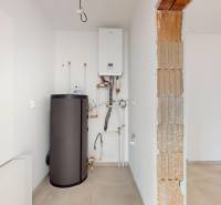 Heating and boiler in the utility room of a family house with tiled flooring.