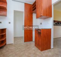 Interior of a family house with a wooden decor kitchen unit and tiled flooring.